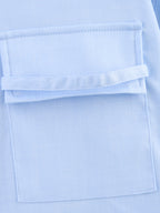 Chemise bleue à manches longues ample, style chic et automnal, inspirée par les coquillages.