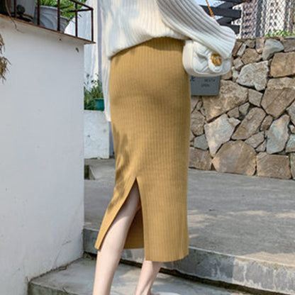 Jupe tricotée femme automne-hiver avec pull, taille haute, mi-longue, en laine épaisse fendue sur les hanches.