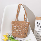Bolso coreano de paja tejida a mano con hilo de algodón recortado y hueco, elegante bolso de un solo hombro, bolso portátil para playa y vacaciones en la playa. 